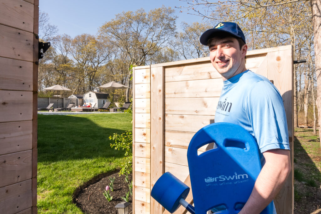 Swim instructor arriving for an at-home lesson in a backyard